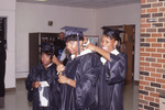 Students Adjusting their Robes at Graduation by East Texas State University