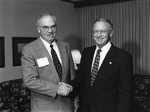 Barry B. Thompson and Jerry Morris Shaking Hands at Merger Press Conference, Front by East Texas State University