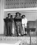 Alpha Phi Alpha Members Speaking on Stage by East Texas State University