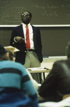 Augustine C. Arize in Front of Blackboard by East Texas State University