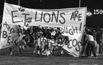 E.T. Football Team Running Through Breakaway Banner by East Texas State University