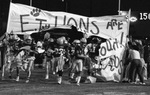 E.T. Football Team Running Through Breakaway Banner by East Texas State University