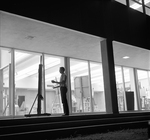 Art Student Painting on Art Building Patio at Night by East Texas State College